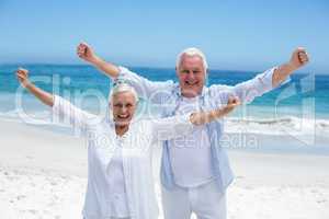 Senior couple outstretching their arms