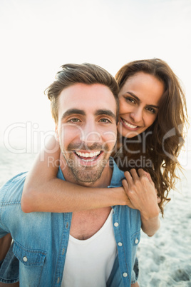 Boyfriend giving piggy back to girlfriend