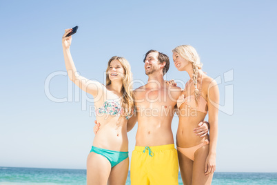 Young friends taking a selfie on the beach