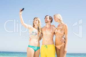 Young friends taking a selfie on the beach