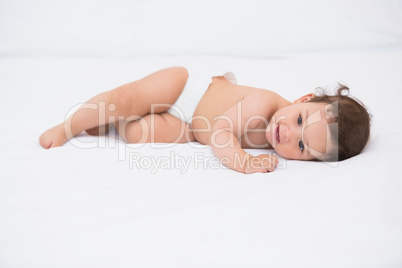 Close-up of baby lying on bed