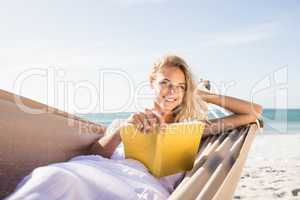 Woman reading book in hammock