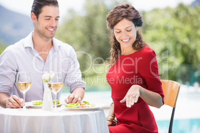 Smiling woman looking at engagement ring