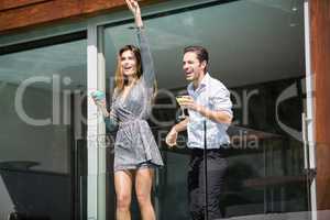 Couple with drinks enjoying in balcony