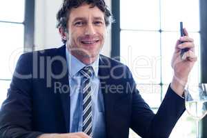 Happy businessman holding a mobile phone