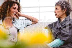 Cheerful mother and daughter at home