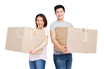 Young couple holding cardboard boxes