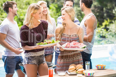Friends preparing for outdoors barbecue party