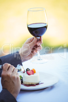 Businesswoman having a desert with wine