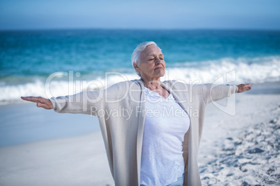 Beautiful mature woman outstretching arms