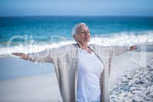 Beautiful mature woman outstretching arms