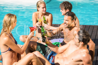 Happy friends enjoying at the swimming pool