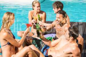 Happy friends enjoying at the swimming pool