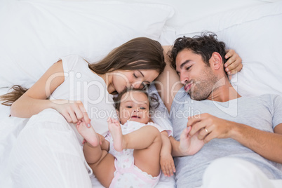 High angle view of couple loving baby on bed