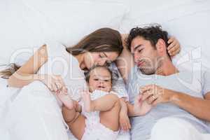 High angle view of couple loving baby on bed