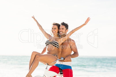 Couple going on a bike ride on the beach