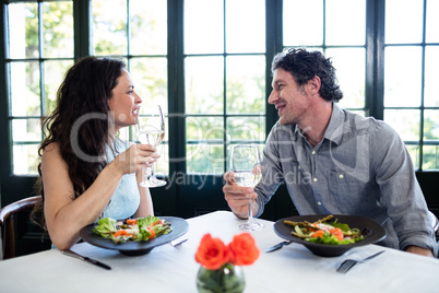 Couple holding wine glass and interacting