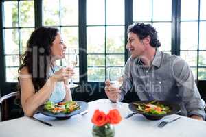 Couple holding wine glass and interacting