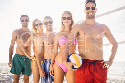 Smiling friends in line after playing volleyball
