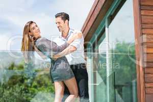 Romantic couple dancing at balcony in resort