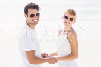 Romantic couple holding hands on the beach