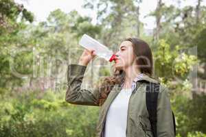 Woman drinking water with backpack