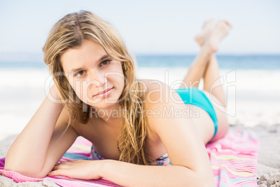 Pretty woman in bikini lying on the beach