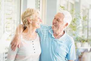 Smiling romantic senior couple at home