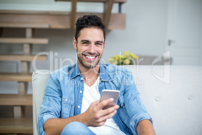 Smiling smart man using smartphone