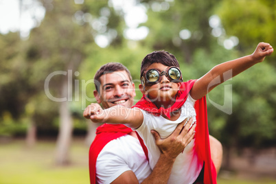 Father and son pretending to be superhero