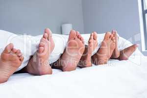 Feet of family sticking out from the quilt