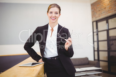 Beautiful businesswoman leaning on counter