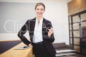 Beautiful businesswoman leaning on counter