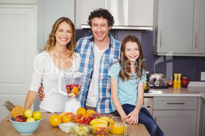 Portrait of smiling family standing at table