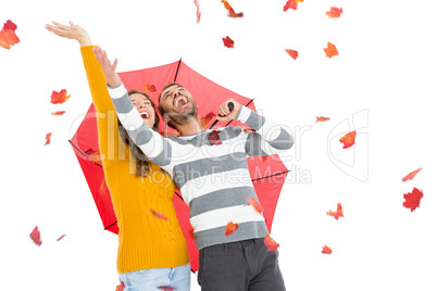 Young couple playing with maple leaves