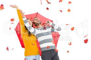 Young couple playing with maple leaves