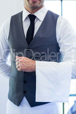 Close-up of waiter standing with napkin
