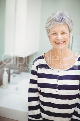 Portrait of senior woman standing in bathroom