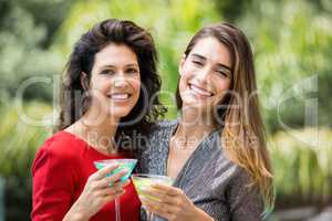 Portrait of beautiful female friends with cocktail