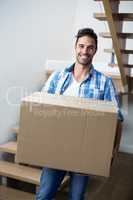 Portrait of handsome man holding box