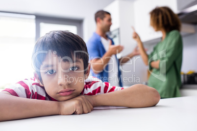 Boy feeling sad while his parents quarrelling