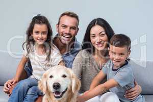 Family with dog in living room