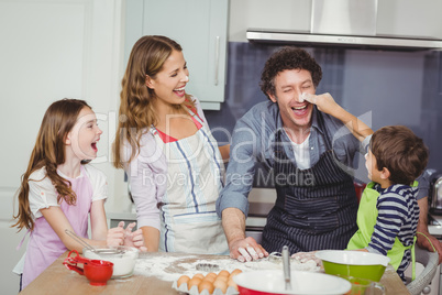 Happy family enjoying while cooking food