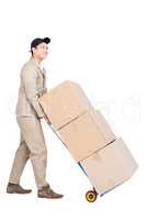Delivery man moving luggage trolley with cardboard boxes
