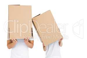 Young couple with cardboard boxes on their heads