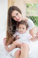 Portrait of young woman with baby girl