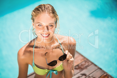 Portrait of beautiful woman smiling near poolside