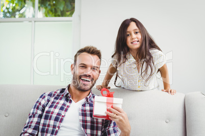Happy daughter and father with gift at home