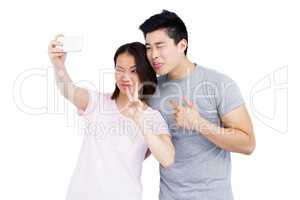 Young couple taking a selfie on smartphone