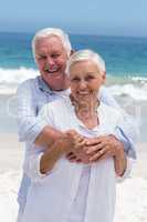 Senior couple embracing with arms around